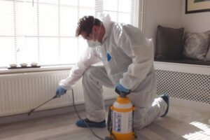 technician spraying for a pest control treatment